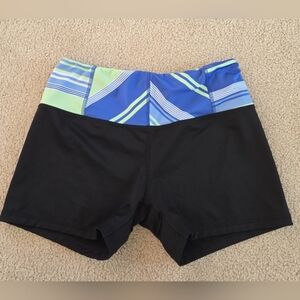MTA Sport athletic large shorts for women. These shorts are black with a blue, g